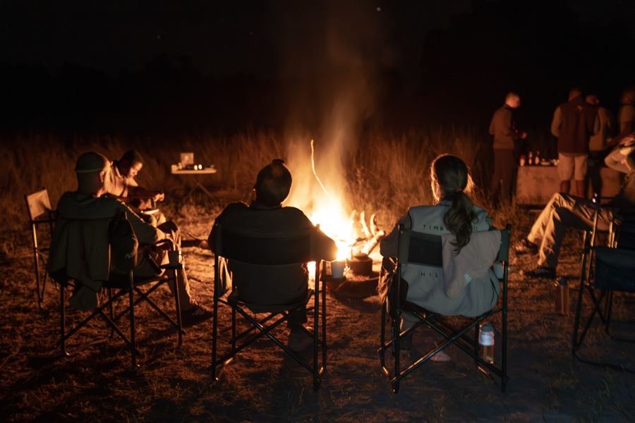 Participants sitting in a circle around the campfire