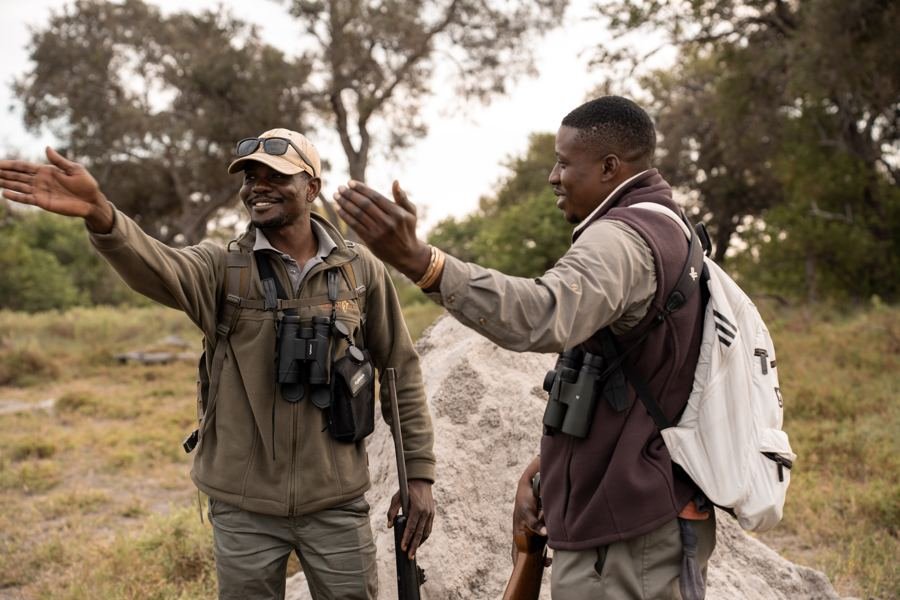 Two guides laughing together in the bush